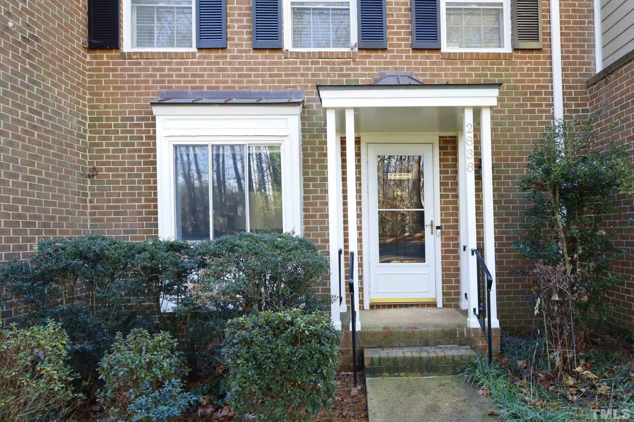 2838 Wycliff Road Raleigh, NC 27607 - Photo 3 of 39 front view of a brick house with a large windows