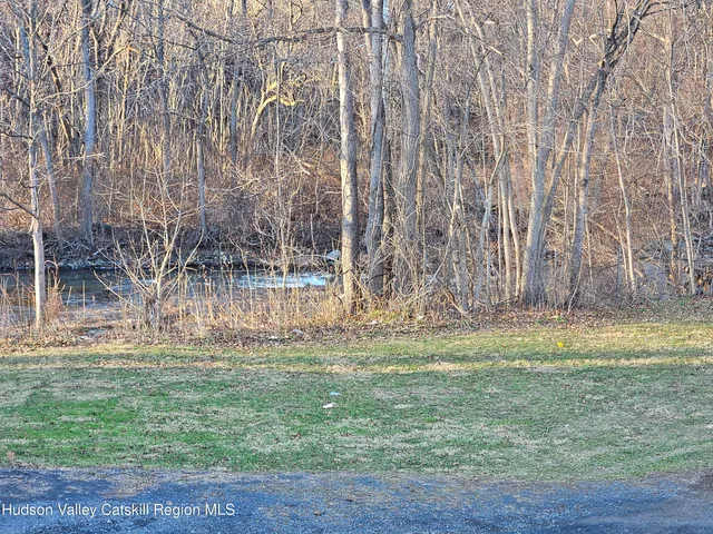 a backyard of apartments with large trees