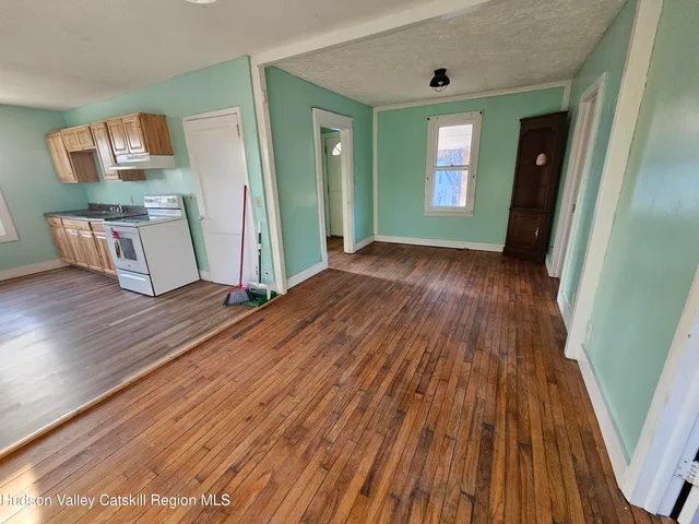 a view of a room with wooden floor and stairs