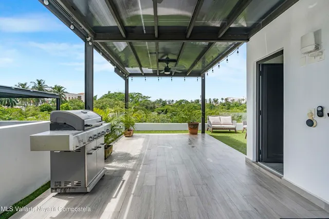 a view of a porch with furniture and a yard