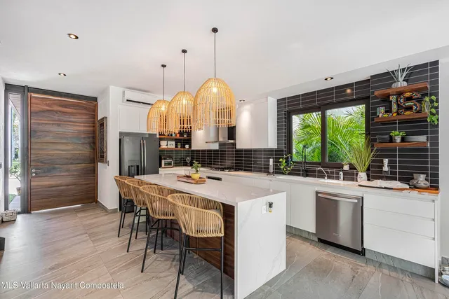 a large kitchen with a table and chairs