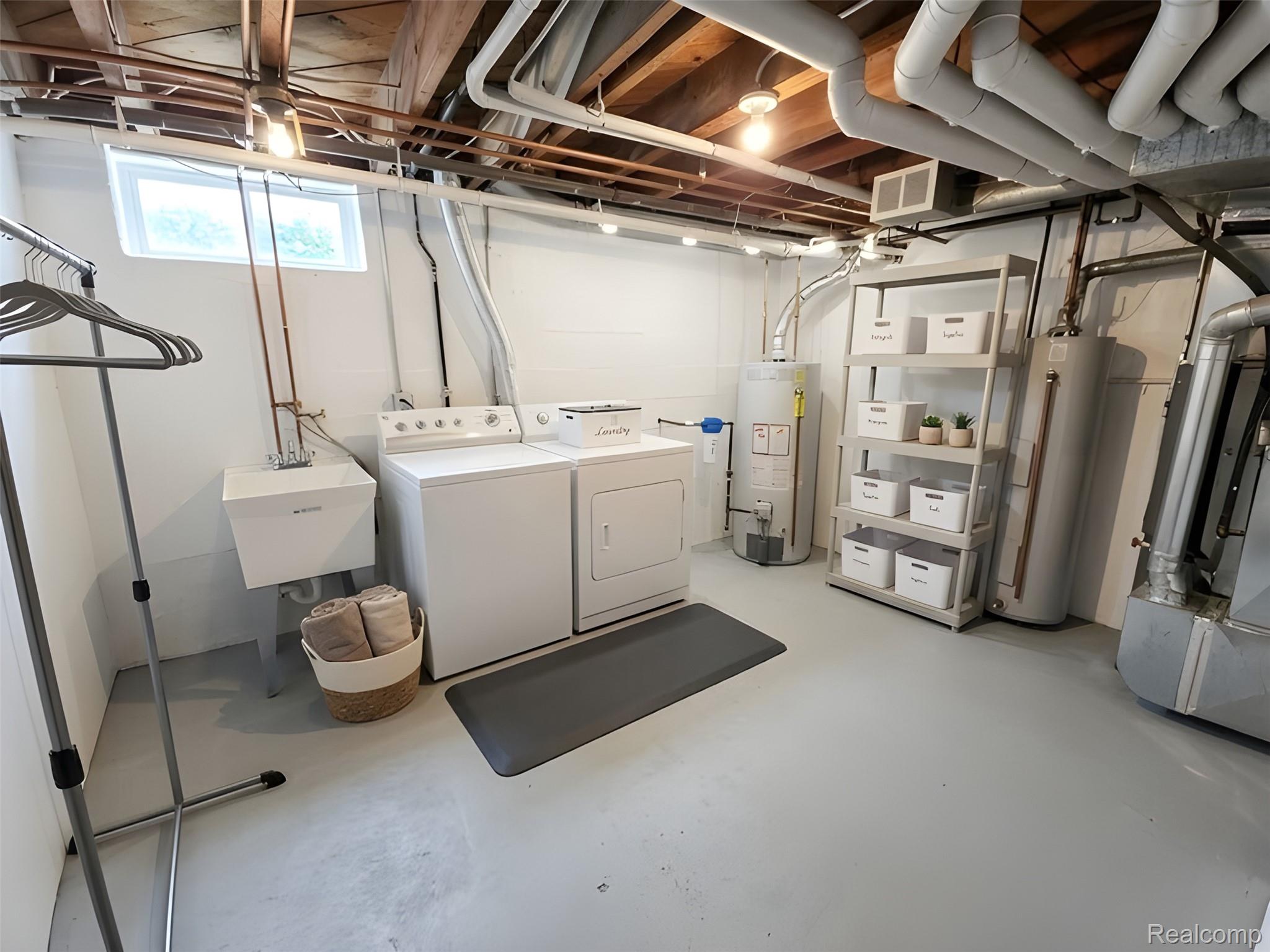 9921 Middlebelt Road, Unit 32 Livonia, MI 48150 - Photo 9 of 11 Dedicated laundry area featuring a utility sink, white washing machine, and white clothes dryer