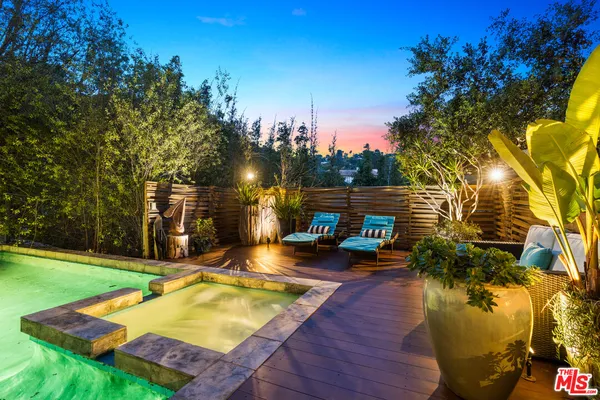 a backyard of a house with a garden and plants