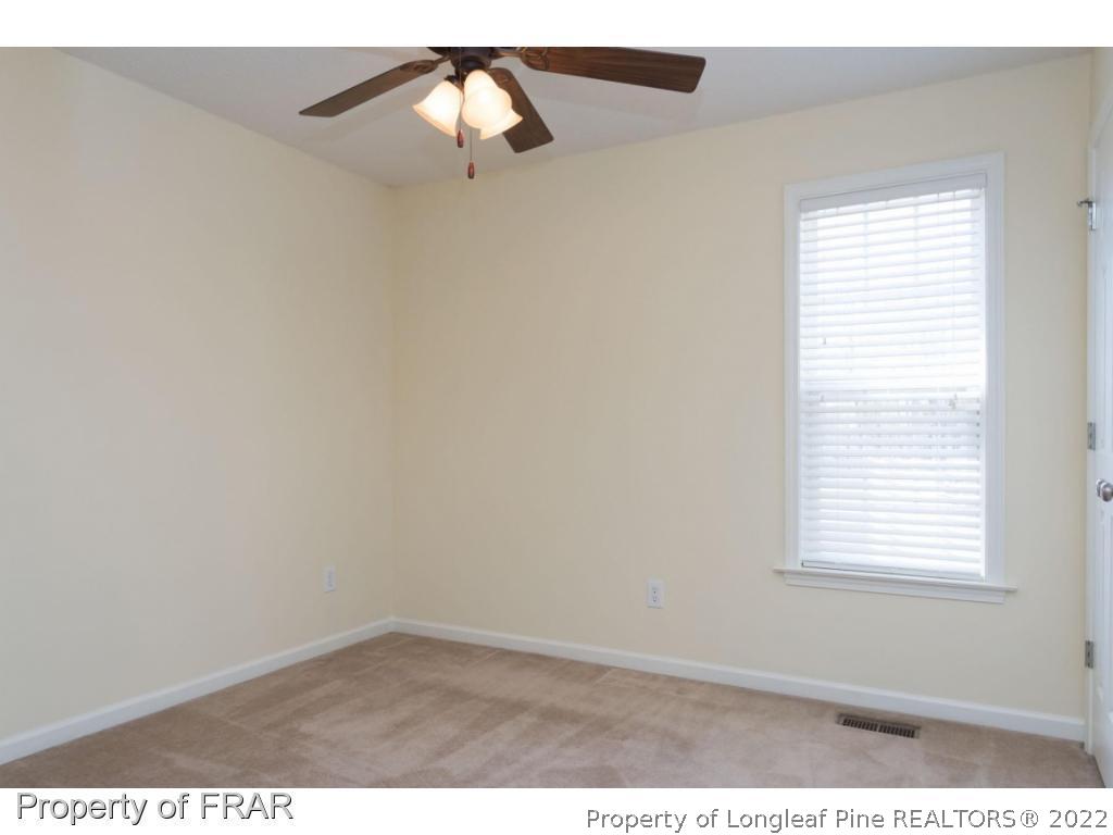 3689 Old Stage Road North Angier, NC 27501 - Photo 16 of 25 an empty room with a window and a ceiling fan