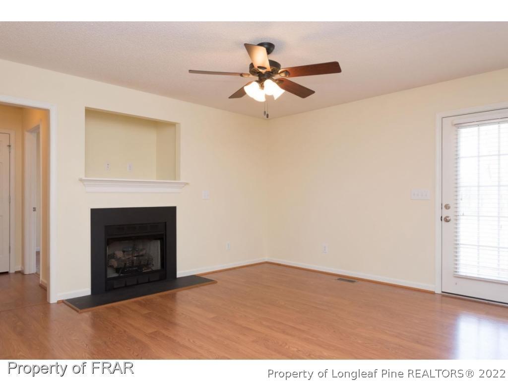 3689 Old Stage Road North Angier, NC 27501 - Photo 4 of 25 a view of an empty room with wooden floor and a fireplace
