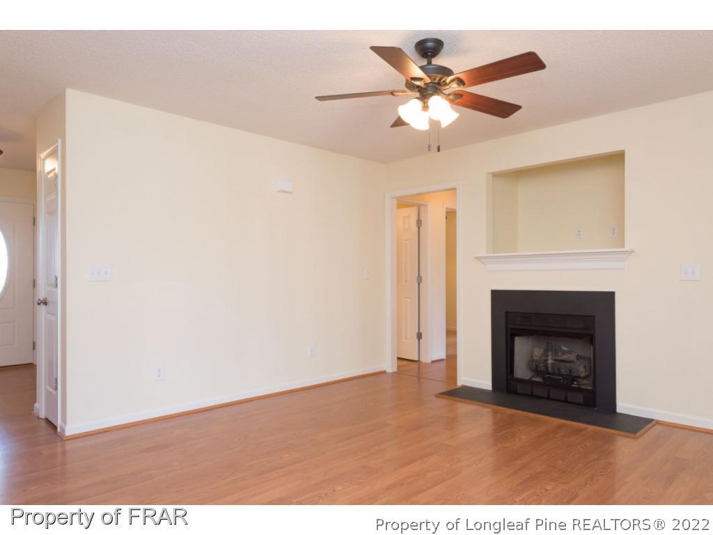 3689 Old Stage Road North Angier, NC 27501 - Photo 5 of 25 a view of an empty room with chandelier fan and fire place