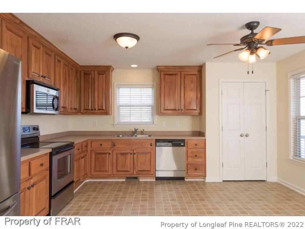 3689 Old Stage Road North Angier, NC 27501 - Photo 7 of 25 a kitchen with granite countertop a sink stainless steel appliances and cabinets