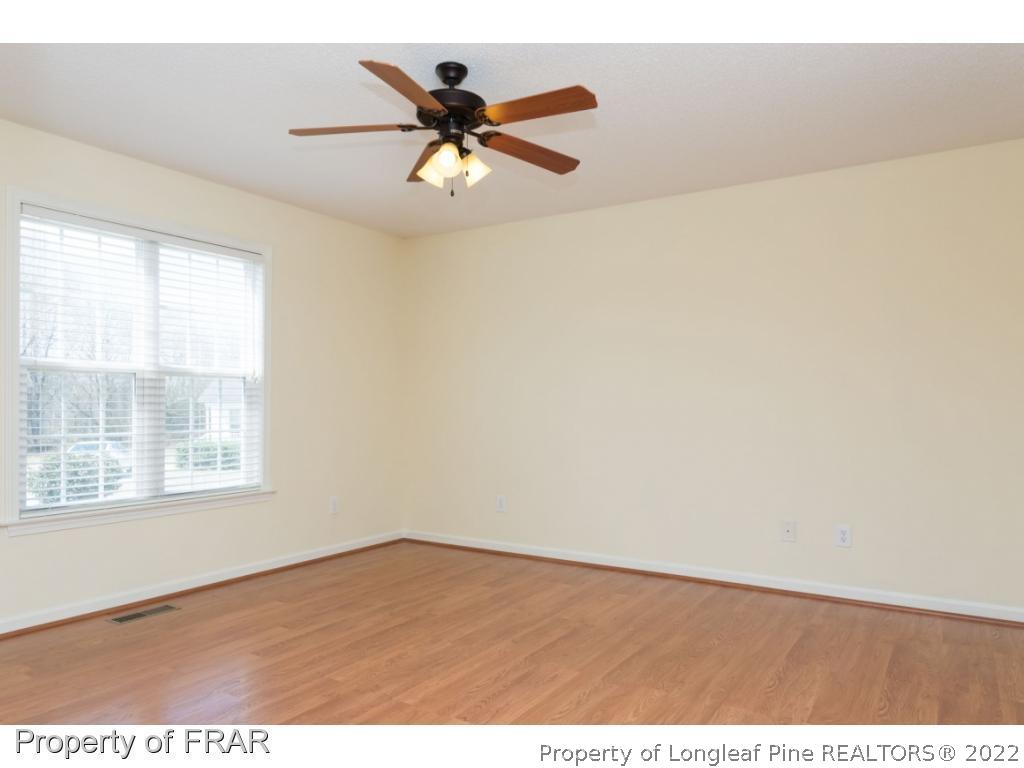 3689 Old Stage Road North Angier, NC 27501 - Photo 10 of 25 an empty room with wooden floor and windows