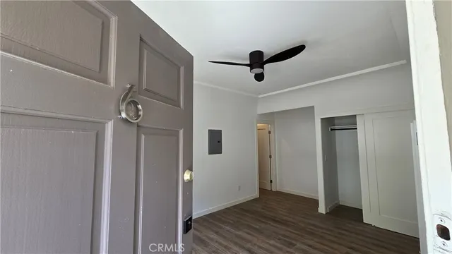 a view of empty room with wooden floor