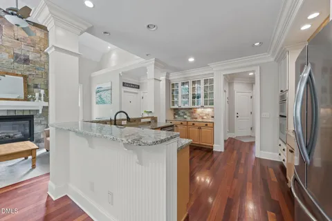 a kitchen with granite countertop a stove top oven sink and cabinets