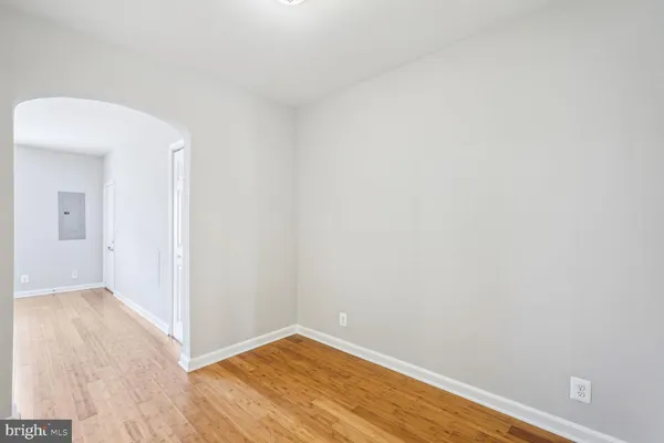 a view of a small space with wooden floor and a bathroom