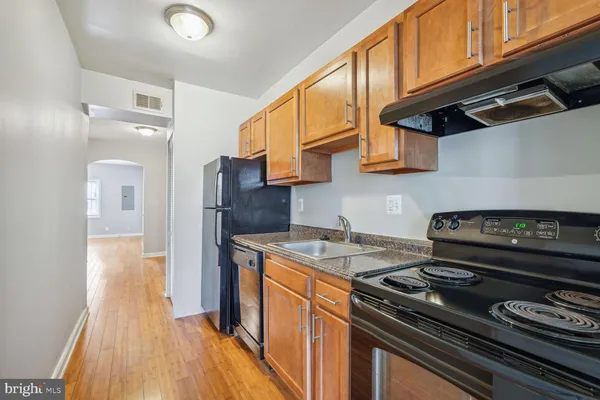 a kitchen with a stove and a refrigerator