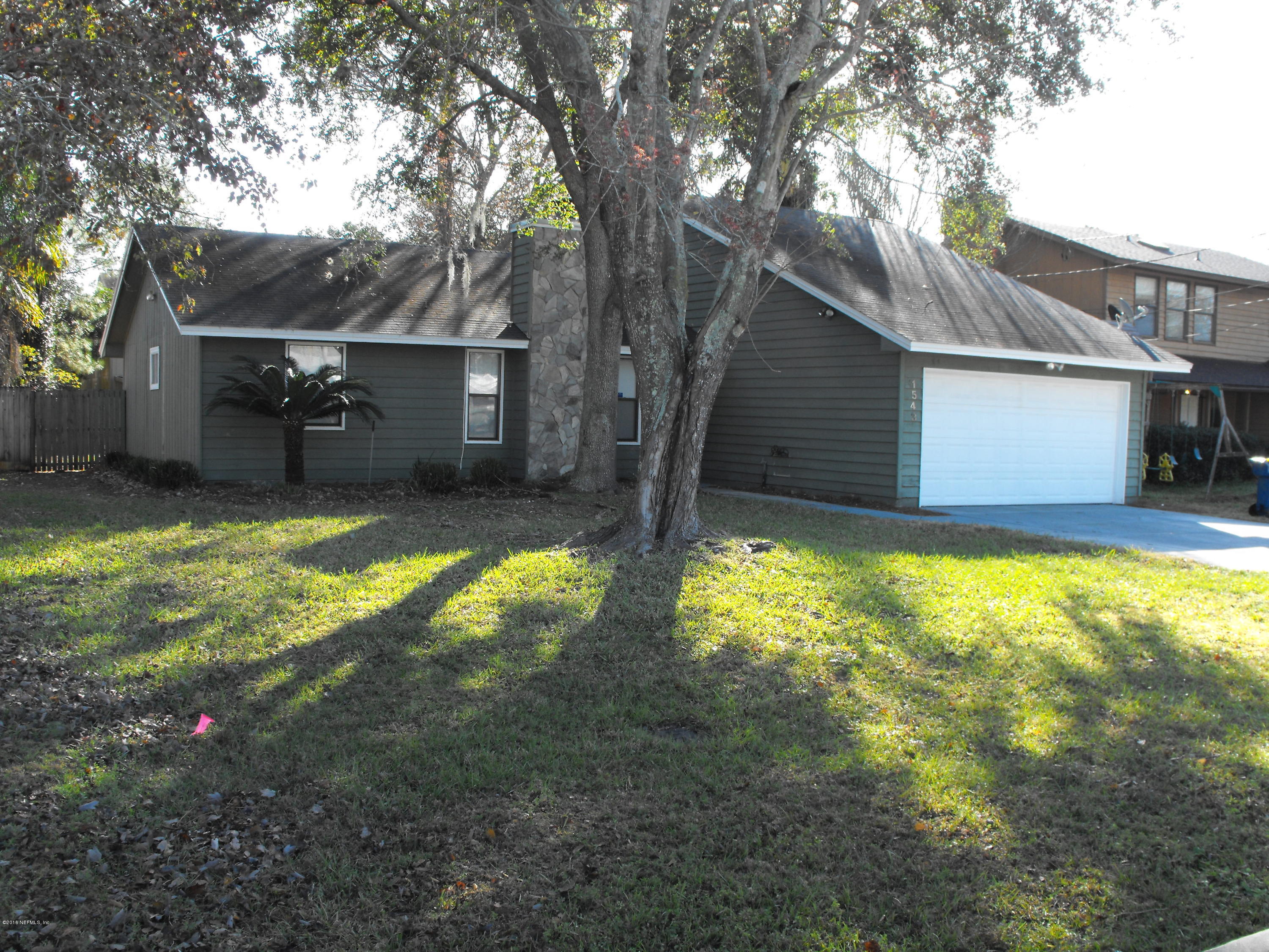 1543 Derringer Road Jacksonville, FL 32225 - Photo 2 of 19 a view of a backyard with a large tree