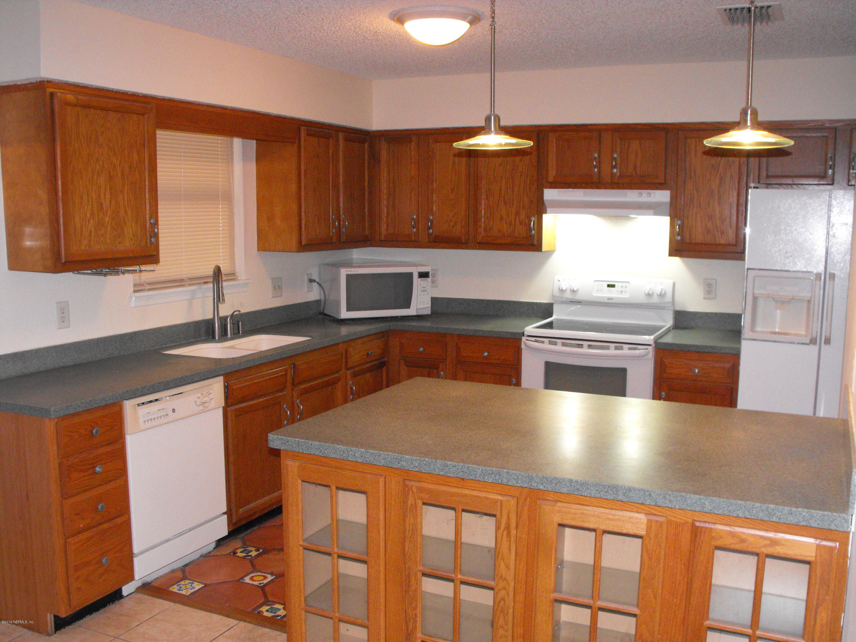 1543 Derringer Road Jacksonville, FL 32225 - Photo 4 of 19 a kitchen with stainless steel appliances granite countertop a sink a stove and a wooden floors