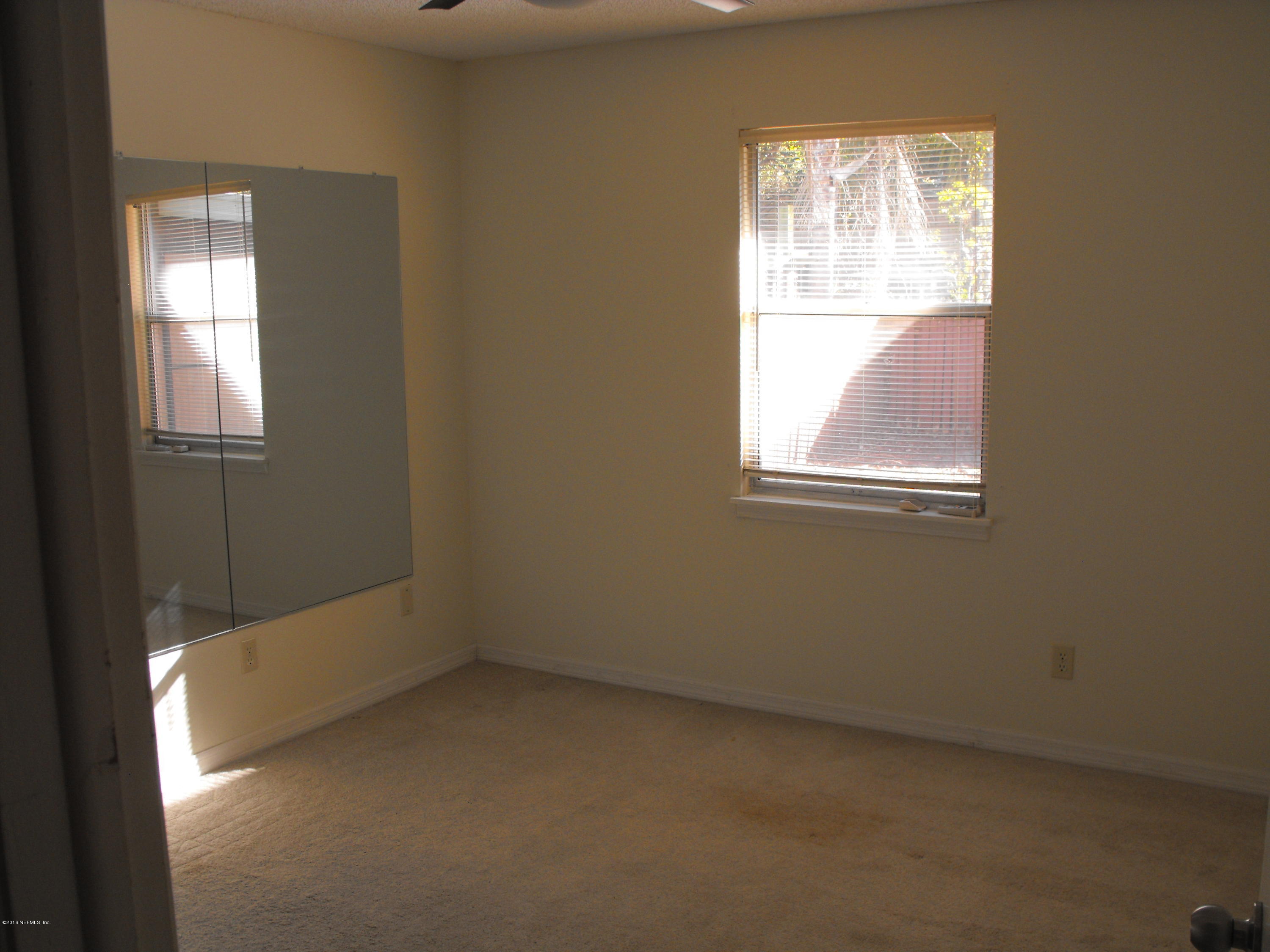1543 Derringer Road Jacksonville, FL 32225 - Photo 6 of 19 an empty room with windows
