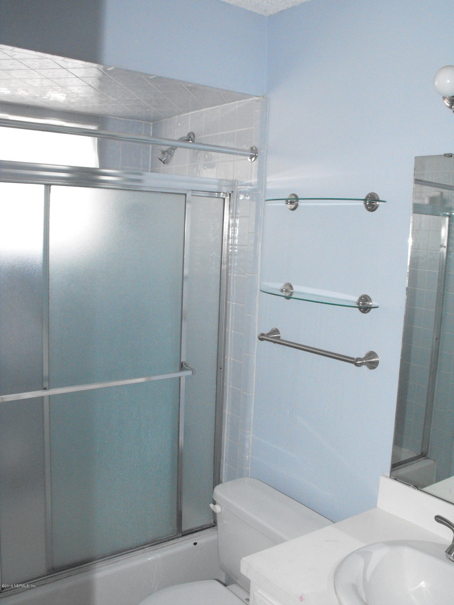 1543 Derringer Road Jacksonville, FL 32225 - Photo 7 of 19 a bathroom with a shower and a toilet