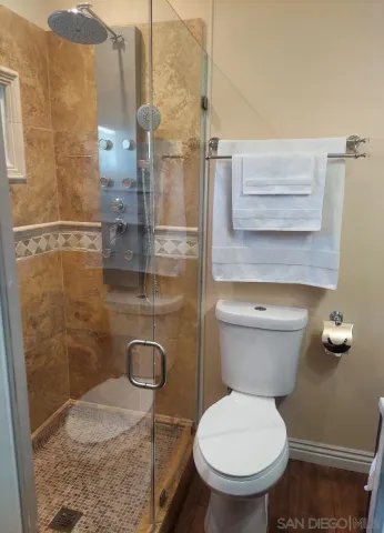 a bathroom with a toilet and a shower