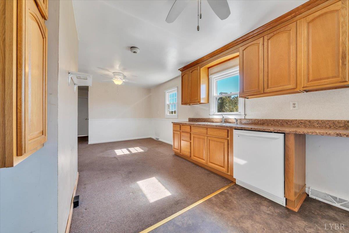 4152 Blue Ridge Drive Gretna, VA 24557 - Photo 14 of 74 a kitchen with stainless steel appliances granite countertop a stove a sink and a refrigerator with cabinets