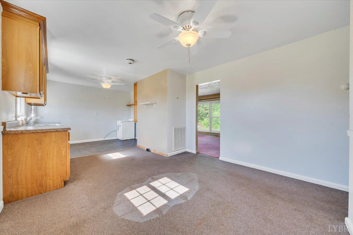 4152 Blue Ridge Drive Gretna, VA 24557 - Photo 16 of 74 a view of kitchen with a sink cabinet a ceiling fan and a kitchen view