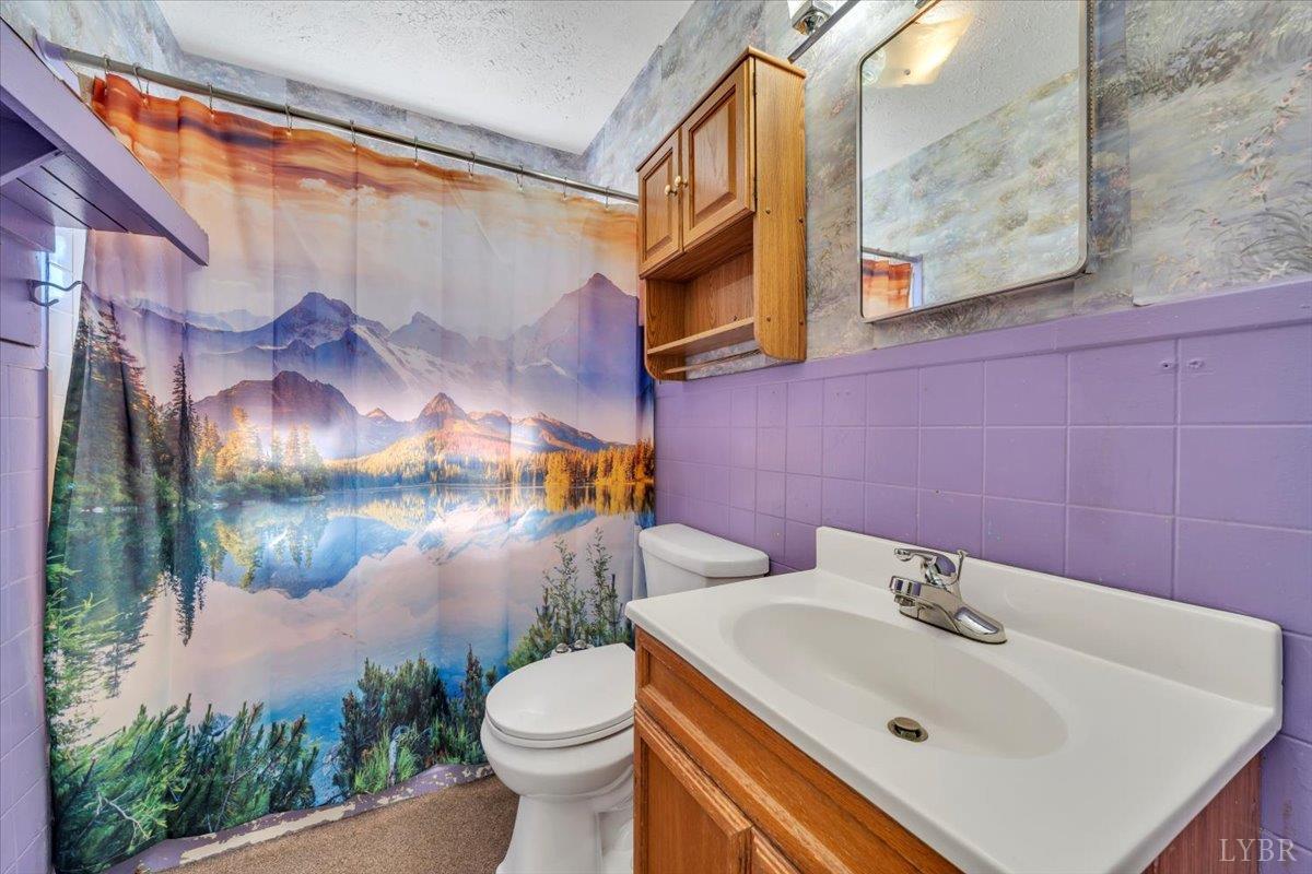 4152 Blue Ridge Drive Gretna, VA 24557 - Photo 23 of 74 a bathroom with a sink and mirror