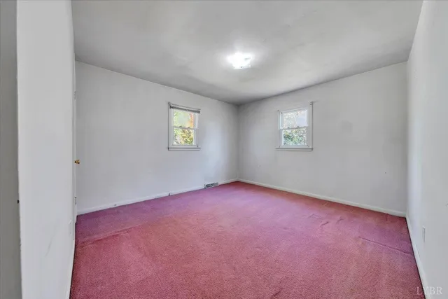 a view of a house with a backyard and a tree