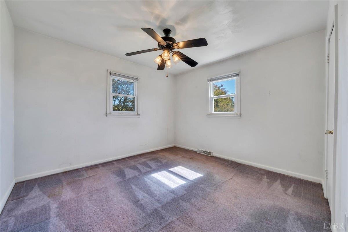 4152 Blue Ridge Drive Gretna, VA 24557 - Photo 27 of 74 an empty room with windows and fan