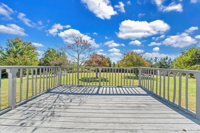 a view of a house with backyard and trees