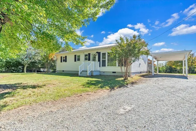 an aerial view of residential houses with outdoor space and river