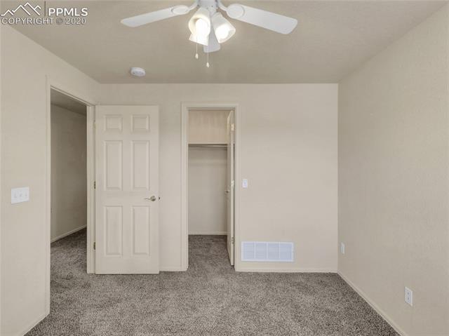 8599 Tibbs Road Peyton, CO 80831 - Photo 24 of 38 Bedroom #3 on main level - new carpeting and it has a walk-in closet!