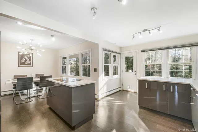 a living room with furniture and large windows