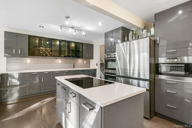 a kitchen with a refrigerator sink and stove top oven