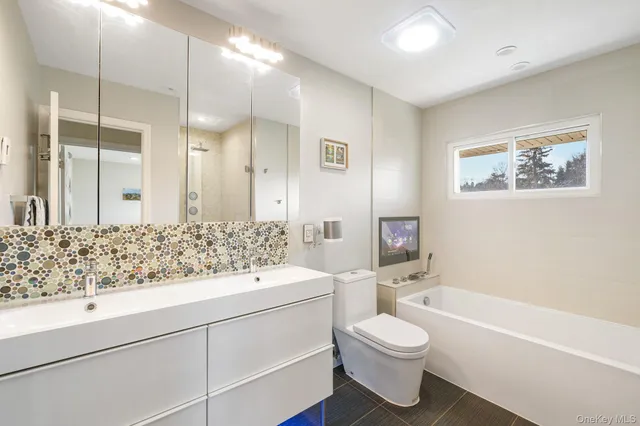 a bathroom with a sink a toilet and a bathtub