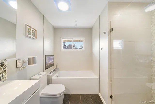 a bathroom with a toilet sink and bathtub