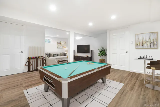 a room with pool table and flat screen tv