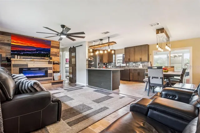 a living room with fireplace furniture and a flat screen tv