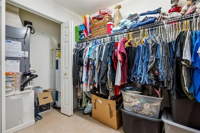 a view of walk in closet with clothes
