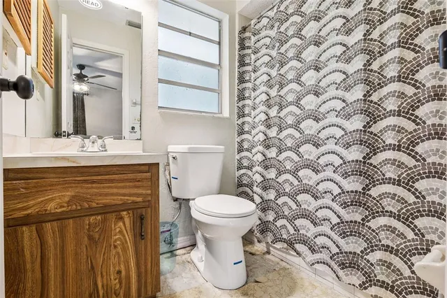a bathroom with a sink toilet and a mirror