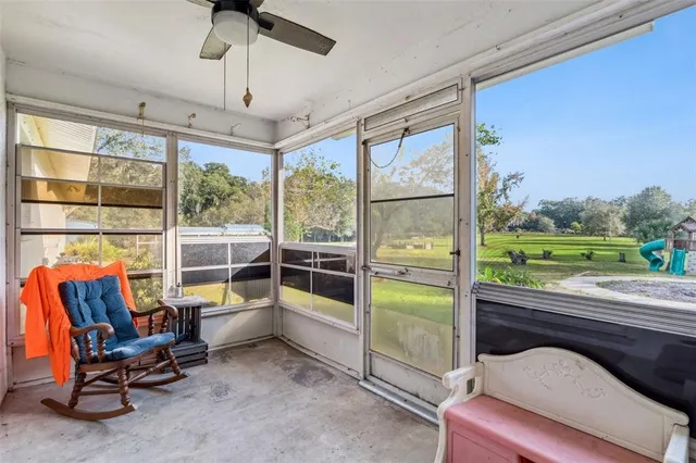 a room with furniture and a floor to ceiling window