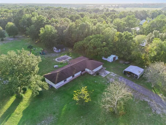 an aerial view of a house with yard
