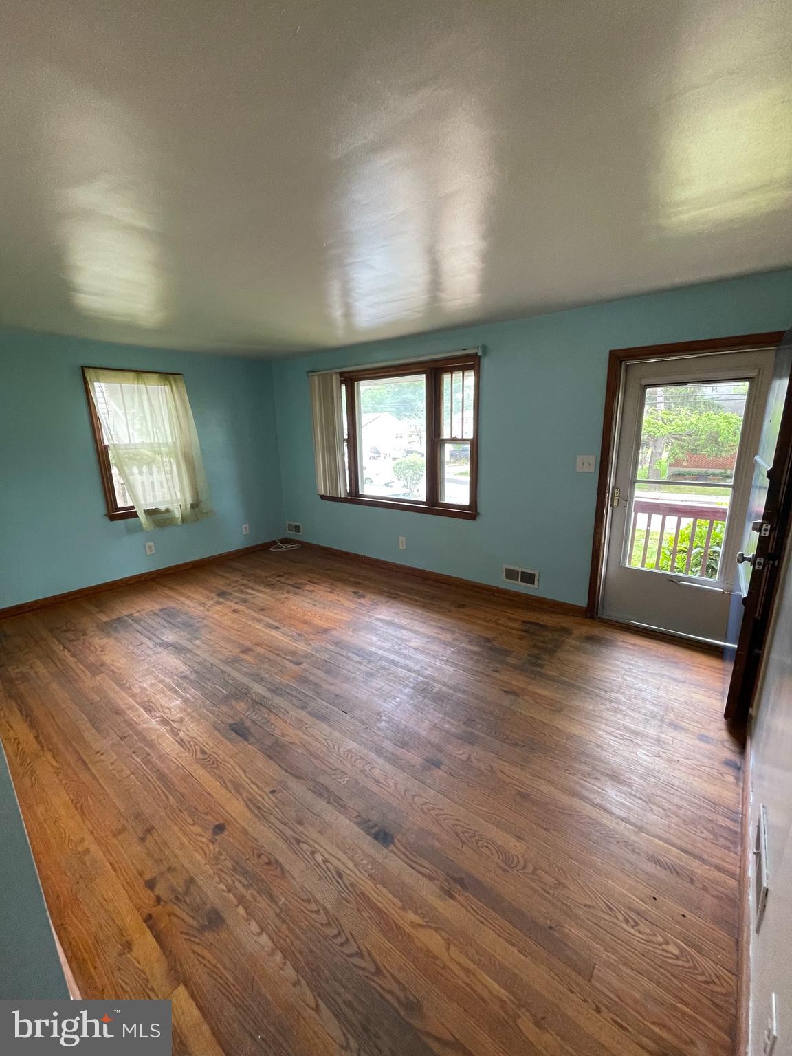 415 West Maple Road Linthicum Heights, MD 21090 - Photo 12 of 12 an empty room with wooden floor and windows