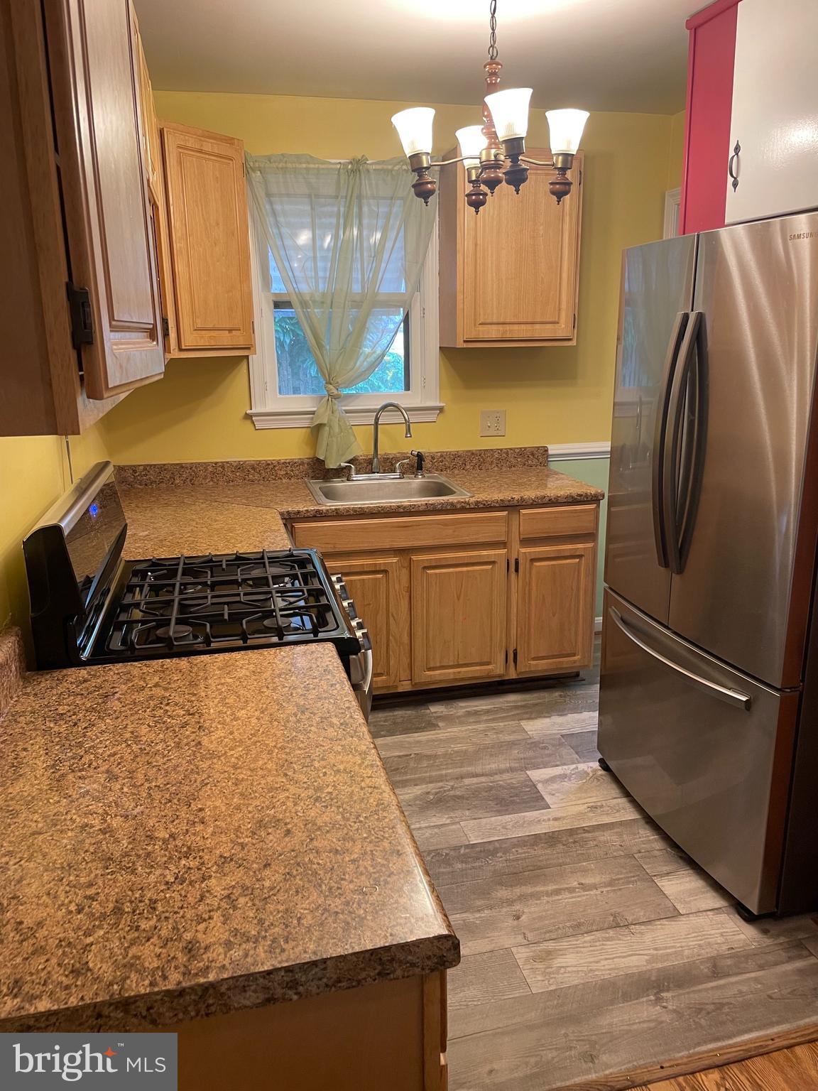415 West Maple Road Linthicum Heights, MD 21090 - Photo 4 of 12 a kitchen with stainless steel appliances granite countertop a sink stove and refrigerator