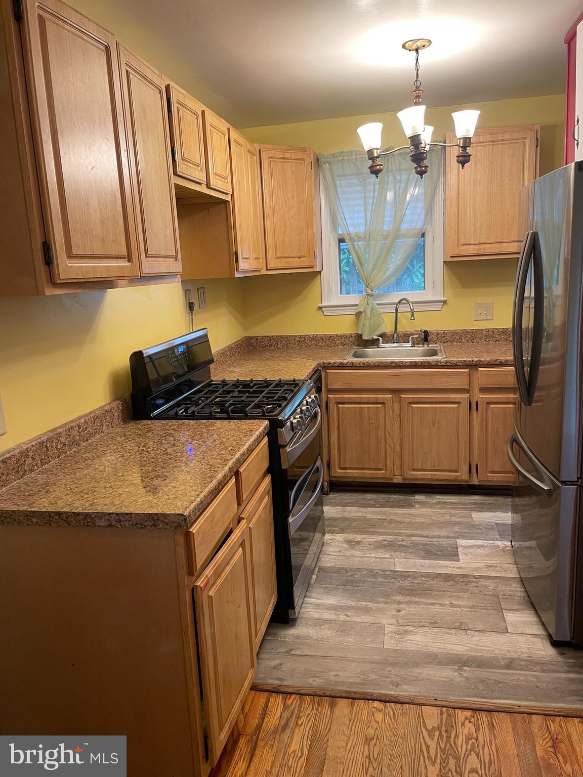 415 West Maple Road Linthicum Heights, MD 21090 - Photo 5 of 12 a kitchen with stainless steel appliances granite countertop a sink stove and refrigerator