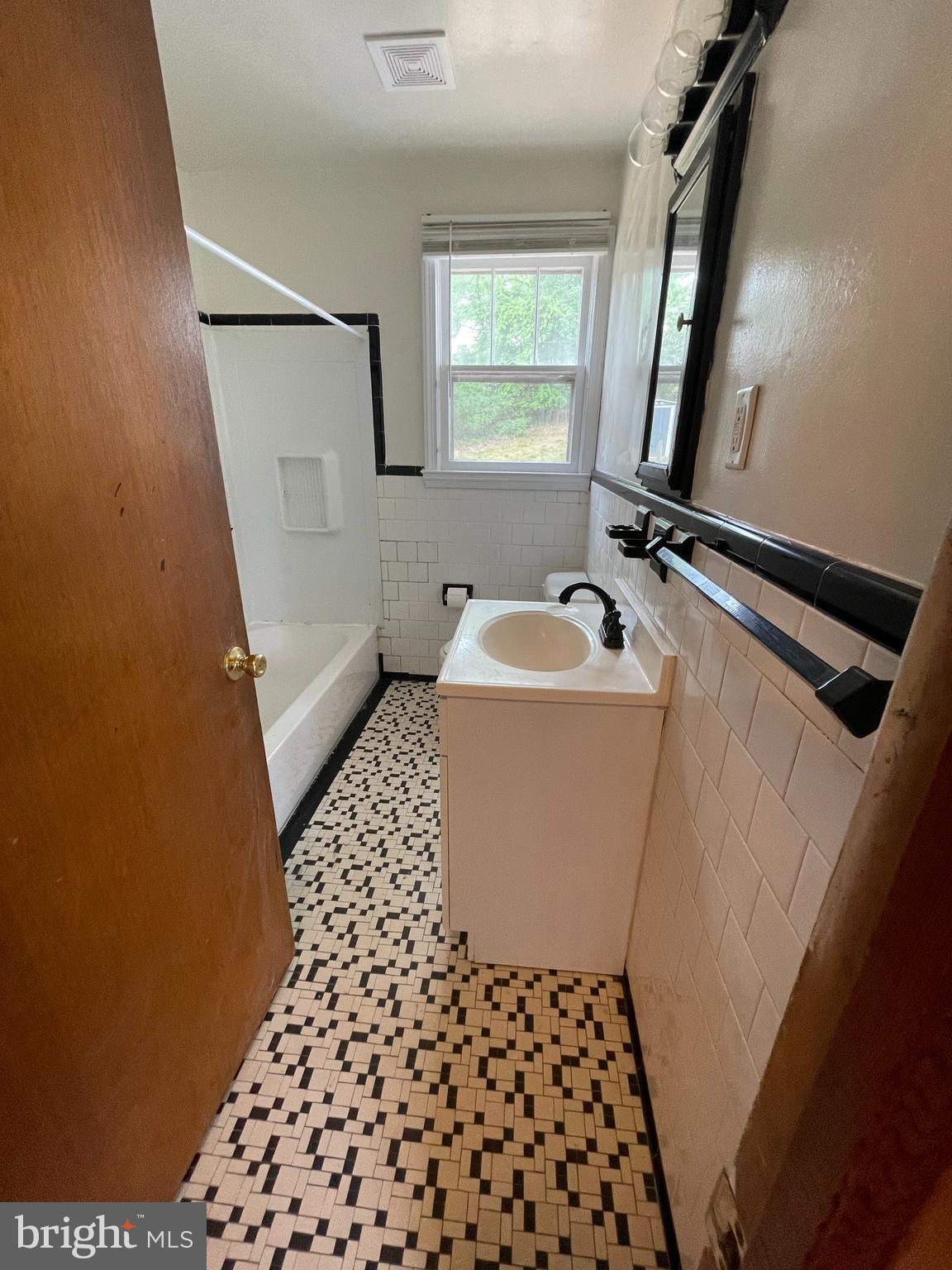 415 West Maple Road Linthicum Heights, MD 21090 - Photo 6 of 12 a bathroom with a sink a toilet a mirror and shower