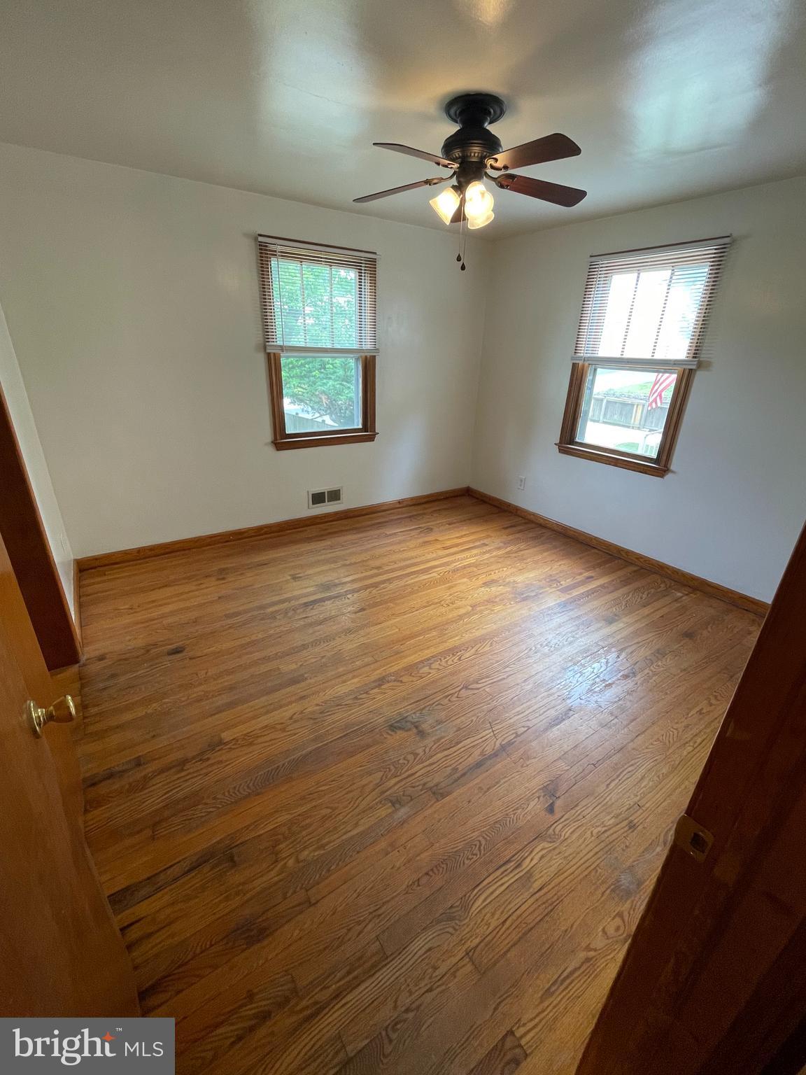 415 West Maple Road Linthicum Heights, MD 21090 - Photo 7 of 12 wooden floor in an empty room with a window