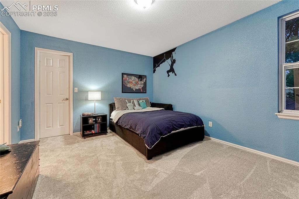 15585 Falcon Ridge Court Colorado Springs, CO 80921 - Photo 30 of 50 a bedroom with a bed and a window