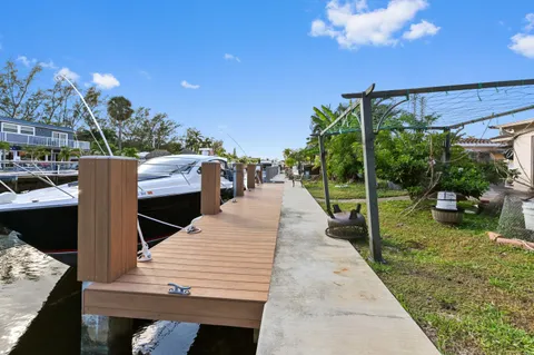 a view of a patio with table and chairs potted plants with wooden floor