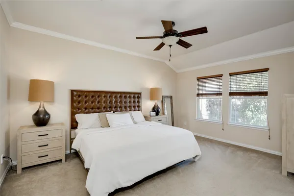 a bedroom with a bed and a lamp