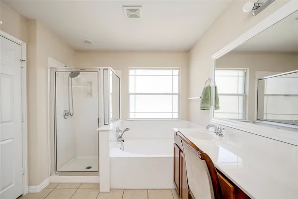 a bedroom with a bed and a lamp on table