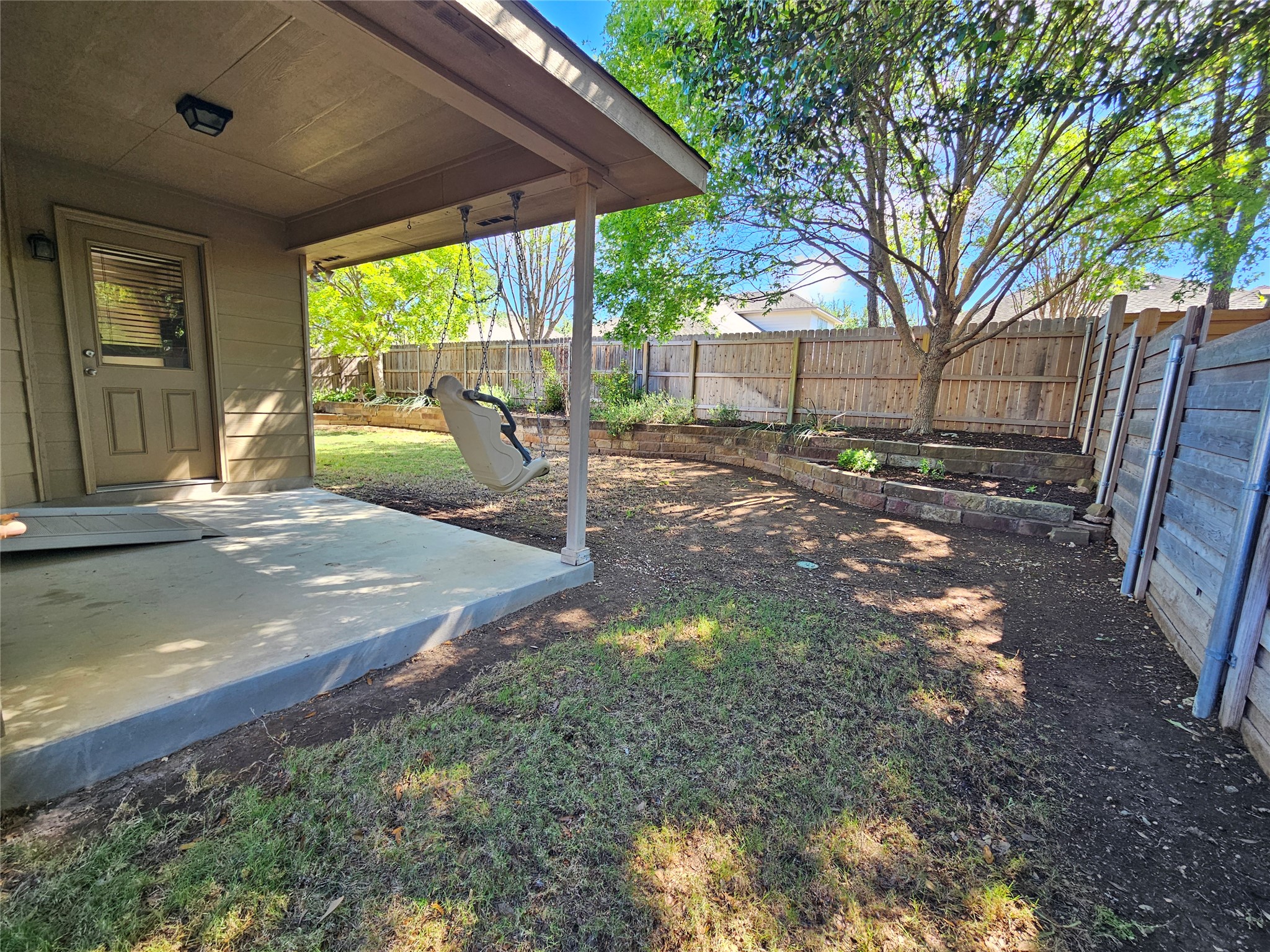 1323 Talley Loop Buda, TX 78610 - Photo 29 of 32 a backyard of a house with table and chairs