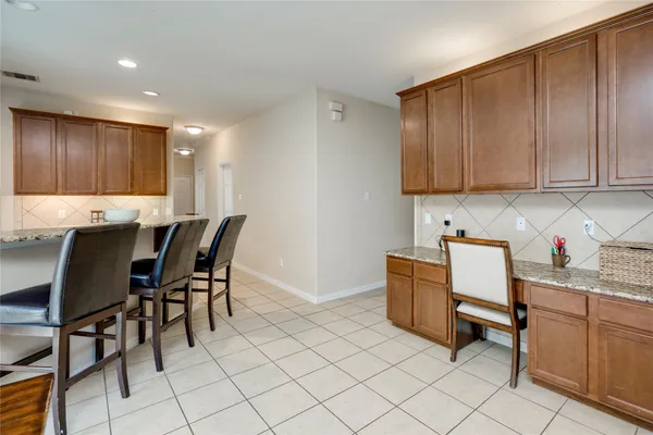 a kitchen with stainless steel appliances granite countertop a refrigerator stove and sink